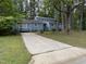 Charming blue house with a long driveway surrounded by lush trees at 507 Holtz Ln, Cary, NC 27511