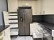 Bright kitchen featuring stainless steel refrigerator, convenient pull-out shelves, and granite countertops at 507 Holtz Ln, Cary, NC 27511