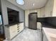Well-lit kitchen with stainless steel refrigerator, granite countertops, and ample cabinet space at 507 Holtz Ln, Cary, NC 27511