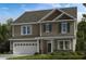 Charming two-story home with a two car garage, neutral siding, and inviting curb appeal at 519 Claftin St, Sanford, NC 27330