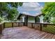 Wooden back deck featuring lattice railings and offering an outdoor living space, with the home's exterior visible at 519 W Raleigh St, Siler City, NC 27344
