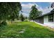 Backyard featuring a green lawn with stepping stones, a picket fence, and mature trees at 519 W Raleigh St, Siler City, NC 27344