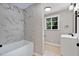 Bright bathroom featuring marble tiled shower and modern vanity at 519 W Raleigh St, Siler City, NC 27344
