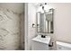Bathroom featuring a sleek vanity with modern fixtures and a tiled shower at 519 W Raleigh St, Siler City, NC 27344