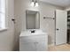 Renovated bathroom with modern fixtures, white vanity, and light wood flooring at 519 W Raleigh St, Siler City, NC 27344