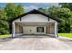 Open carport featuring a white-painted structure, black trim, lattice details, and a concrete floor at 519 W Raleigh St, Siler City, NC 27344