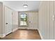 Bright entryway featuring wood floors, paneled walls, and a window providing natural light at 519 W Raleigh St, Siler City, NC 27344