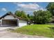 Angle shot of the home's exterior showing the carport, lawn, and siding at 519 W Raleigh St, Siler City, NC 27344