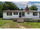 Charming home featuring black shutters, a red chimney, and a concrete patio with a well-maintained yard at 519 W Raleigh St, Siler City, NC 27344