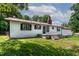 Exterior shot featuring a white one-story home with a red roof, black shutters, and a concrete front patio at 519 W Raleigh St, Siler City, NC 27344