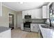 Updated kitchen features stainless steel appliances, granite countertops, and white cabinetry at 519 W Raleigh St, Siler City, NC 27344