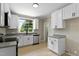 Updated kitchen with white cabinetry and stainless steel appliances at 519 W Raleigh St, Siler City, NC 27344
