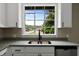 Kitchen featuring granite countertops, modern cabinetry, and a large window view at 519 W Raleigh St, Siler City, NC 27344