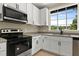 Bright kitchen with stainless steel appliances, granite countertops and a large window at 519 W Raleigh St, Siler City, NC 27344