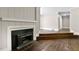 Cozy living room with fireplace, hardwood floors, and access to hallway at 519 W Raleigh St, Siler City, NC 27344