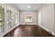 Living room features hardwood floors, light-filled windows, and light paint at 519 W Raleigh St, Siler City, NC 27344