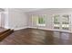 Spacious living room features beautiful hardwood floors, large windows, and neutral wall colors at 519 W Raleigh St, Siler City, NC 27344