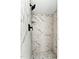 Modern shower tiled with elegant marble and featuring sleek black fixtures at 519 W Raleigh St, Siler City, NC 27344