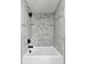 Modern shower with marble tile and updated black fixtures at 519 W Raleigh St, Siler City, NC 27344