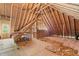 Open attic space with exposed beams, flooring, and framed doorway at 5233 Greymoss Ln, Apex, NC 27539