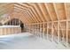 Spacious attic with exposed wood beams, framing, and flooring at 5233 Greymoss Ln, Apex, NC 27539