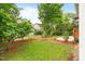 Lush backyard with a green lawn, mulched flower beds, and privacy fence at 5233 Greymoss Ln, Apex, NC 27539