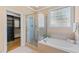 Elegant bathroom with a glass shower, large soaking tub, and a window at 5233 Greymoss Ln, Apex, NC 27539