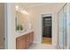 Bright bathroom featuring a double vanity, walk-in shower, and walk-in closet at 5233 Greymoss Ln, Apex, NC 27539