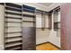 Walk-in closet featuring custom shelving, drawers, and ample storage space at 5233 Greymoss Ln, Apex, NC 27539