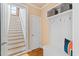 Charming entryway with hardwood floors, coat rack, and staircase to the upper level at 5233 Greymoss Ln, Apex, NC 27539