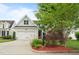 Charming home featuring a well-maintained front yard and a two-car garage at 5233 Greymoss Ln, Apex, NC 27539