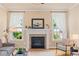 Living room fireplace featuring a decorative mantel, tile surround, and natural light at 5233 Greymoss Ln, Apex, NC 27539