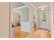 Inviting foyer with hardwood floors, arched entryways, and wainscoting at 5233 Greymoss Ln, Apex, NC 27539
