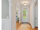 Bright foyer with hardwood floors, arched doorways, and a view into the living room at 5233 Greymoss Ln, Apex, NC 27539