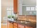 Close-up on kitchen sink area with granite counters, stainless steel appliances, and wood cabinetry at 5233 Greymoss Ln, Apex, NC 27539