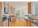 Spacious kitchen features wooden cabinets, stainless appliances, and access to the sunny dining area at 5233 Greymoss Ln, Apex, NC 27539