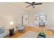 Open living area showcasing hardwood floors, neutral walls, and arched doorways to other rooms at 5233 Greymoss Ln, Apex, NC 27539