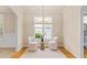 Comfortable sitting area with lots of light and a small table to hold drinks at 5233 Greymoss Ln, Apex, NC 27539