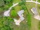 Aerial of home with spacious backyard, mature trees, long driveway, and lush landscaping at 5804 Heathill Ct, Raleigh, NC 27603