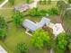 Home aerial showcasing the property's layout, mature trees, and circular driveway at 5804 Heathill Ct, Raleigh, NC 27603