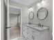 Bathroom featuring double sink vanity with granite countertop and modern fixtures, adjacent to a bedroom at 5804 Heathill Ct, Raleigh, NC 27603