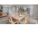 Eat-in dining area features a wood table set for six guests next to a modern kitchen at 5804 Heathill Ct, Raleigh, NC 27603