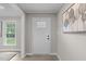 Entryway with white front door, neutral walls, and modern decor accents at 5804 Heathill Ct, Raleigh, NC 27603