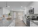 Open concept kitchen with stainless appliances, modern cabinetry, and island with seating at 5804 Heathill Ct, Raleigh, NC 27603