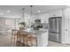 Modern kitchen with white cabinets, granite countertops, stainless steel appliances and eat in counter at 5804 Heathill Ct, Raleigh, NC 27603