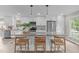Bright, modern kitchen with granite counters, stainless appliances, and seating for three at the island at 5804 Heathill Ct, Raleigh, NC 27603