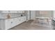 View of a modern kitchen with granite countertops, white cabinetry, and eat-in breakfast nook at 5804 Heathill Ct, Raleigh, NC 27603