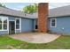 Spacious backyard patio adjacent to the house, featuring a brick chimney and convenient outdoor access at 5804 Heathill Ct, Raleigh, NC 27603