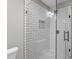 Beautiful tiled shower with glass door, featuring built-in shelving and modern fixtures at 5804 Heathill Ct, Raleigh, NC 27603