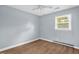 Bedroom featuring hardwood floors, one window, light blue walls, and a ceiling fan at 5805 Craig Rd, Durham, NC 27712